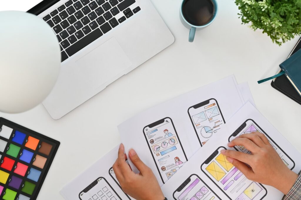 Creative designer working on development project for mobile application at modern workplace